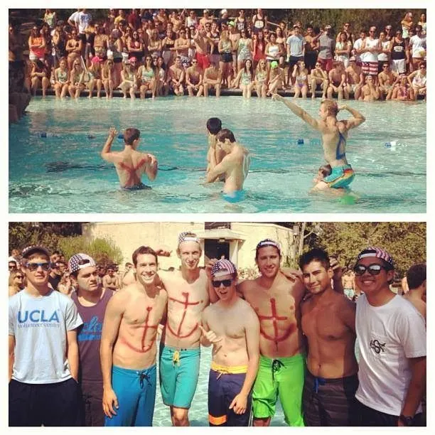 Brothers with red anchors painted on their chests in the pool and posing poolside at Delta Gamma Anchor Splash