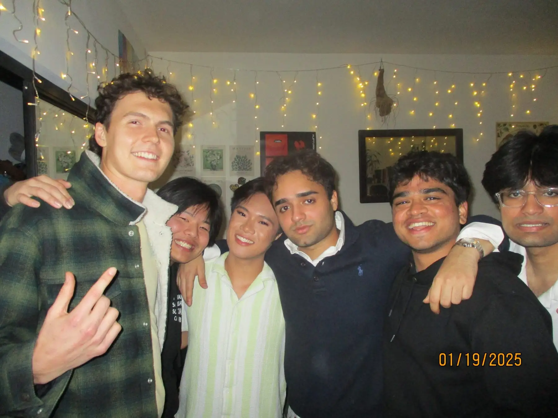 Six friends under string lights at a house gathering