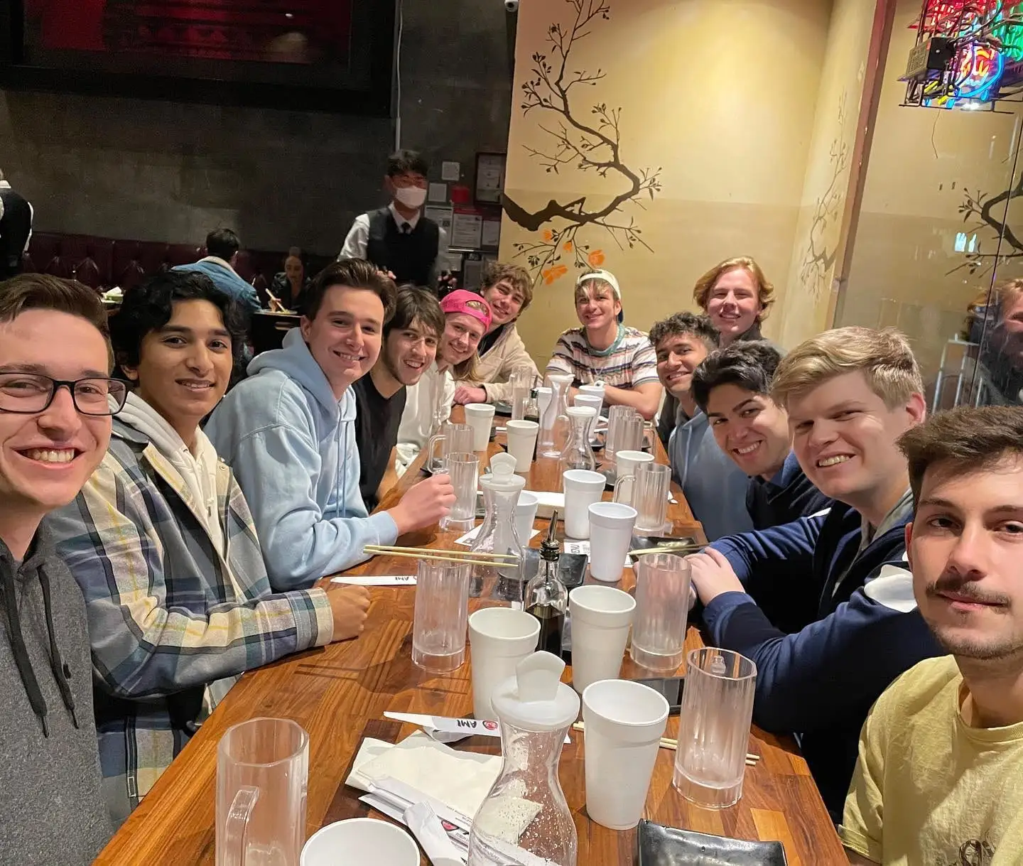 long dinner table full of brothers