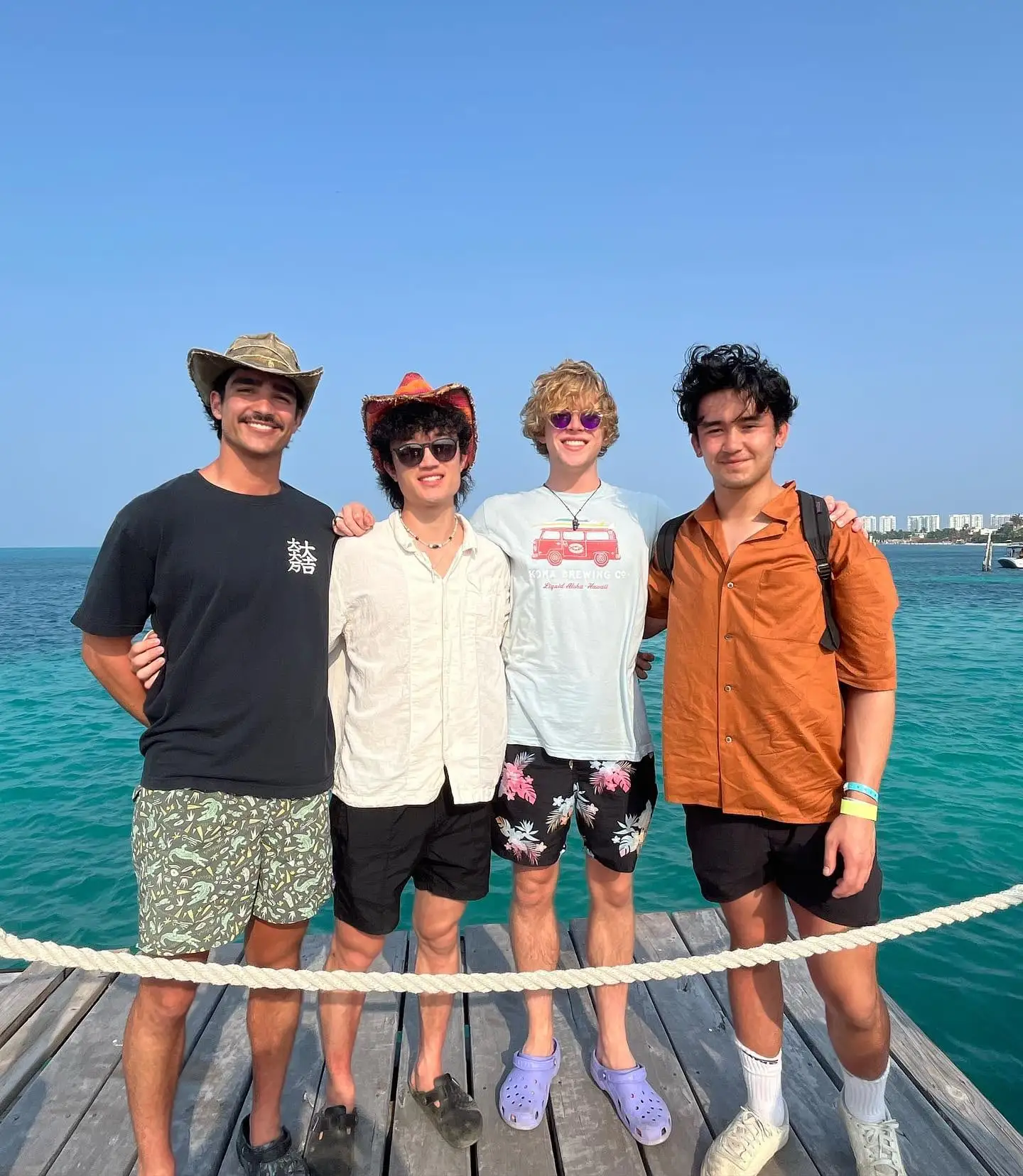 four guys on ocean dock