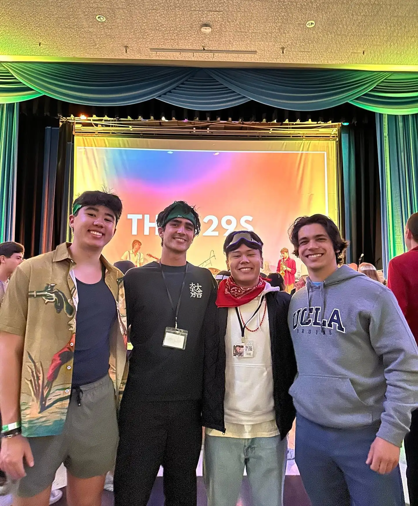 Three friends backstage-pass grinning at a concert