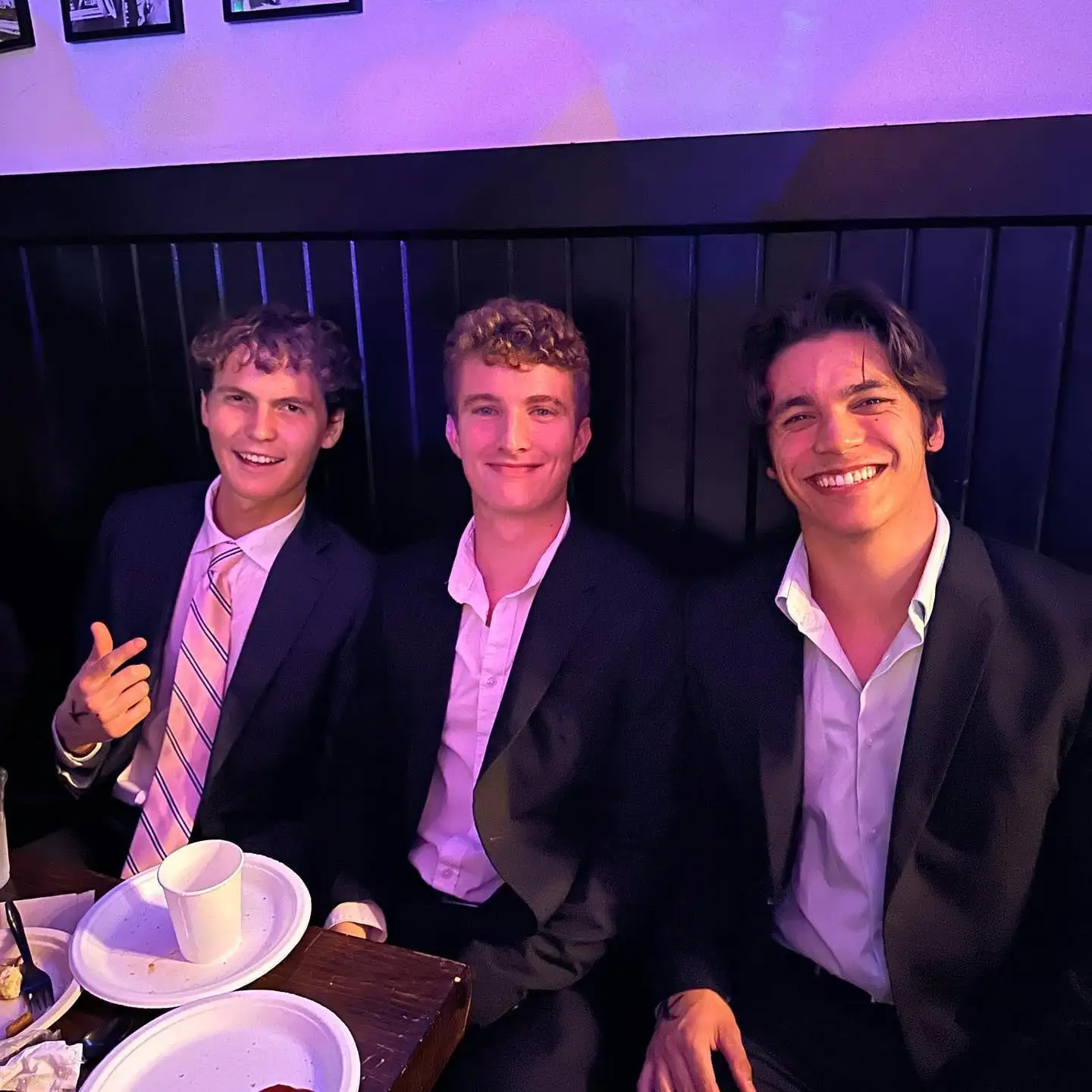 three suits at candlelit table