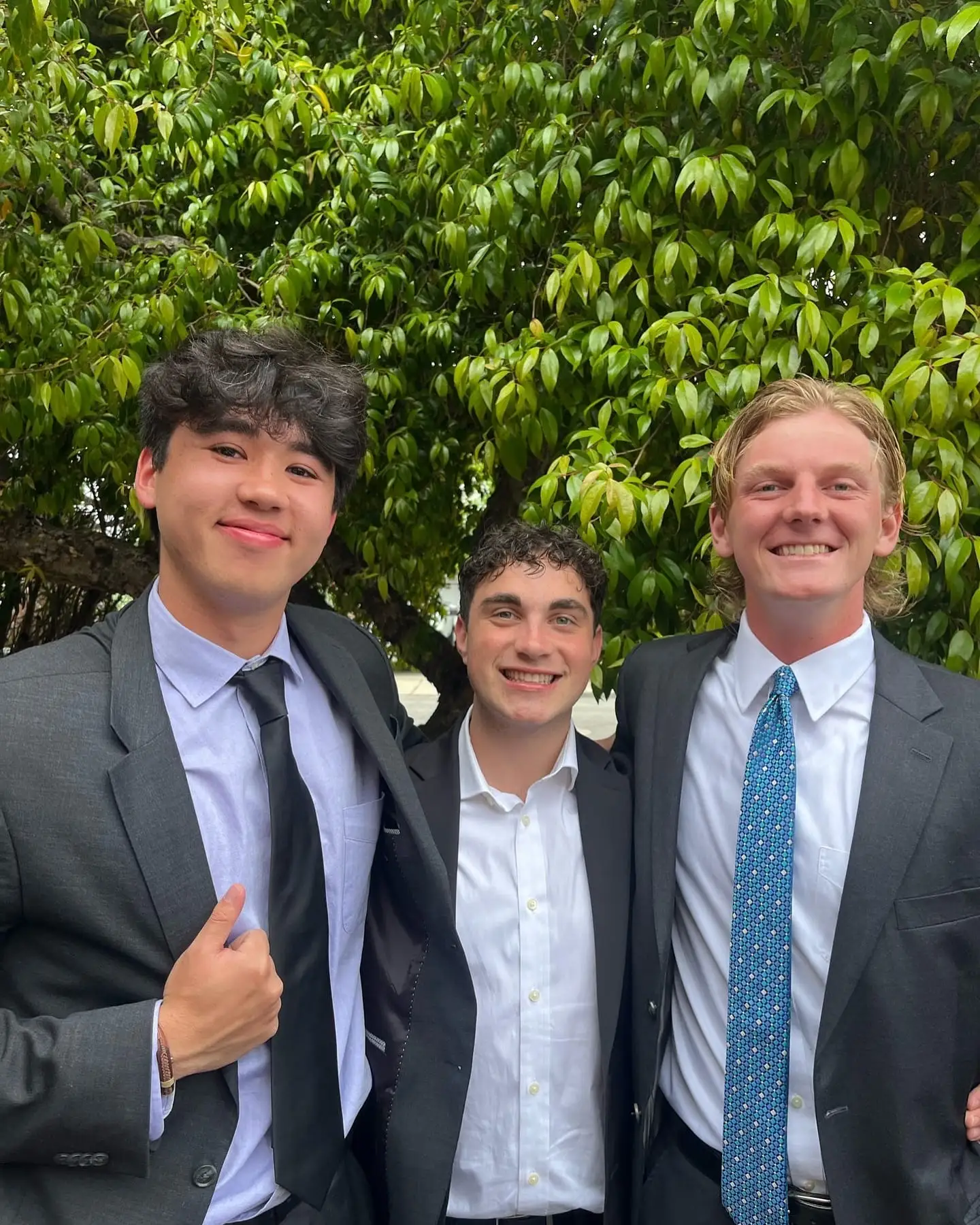 three suited brothers, big grins