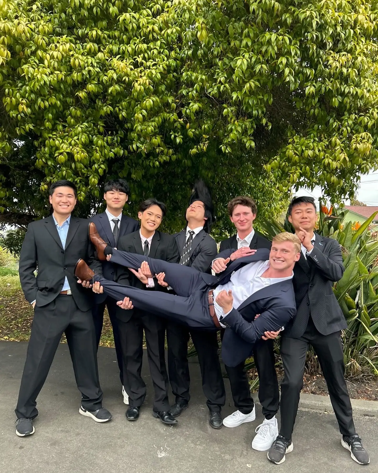 suits playfully carrying a brother horizontal