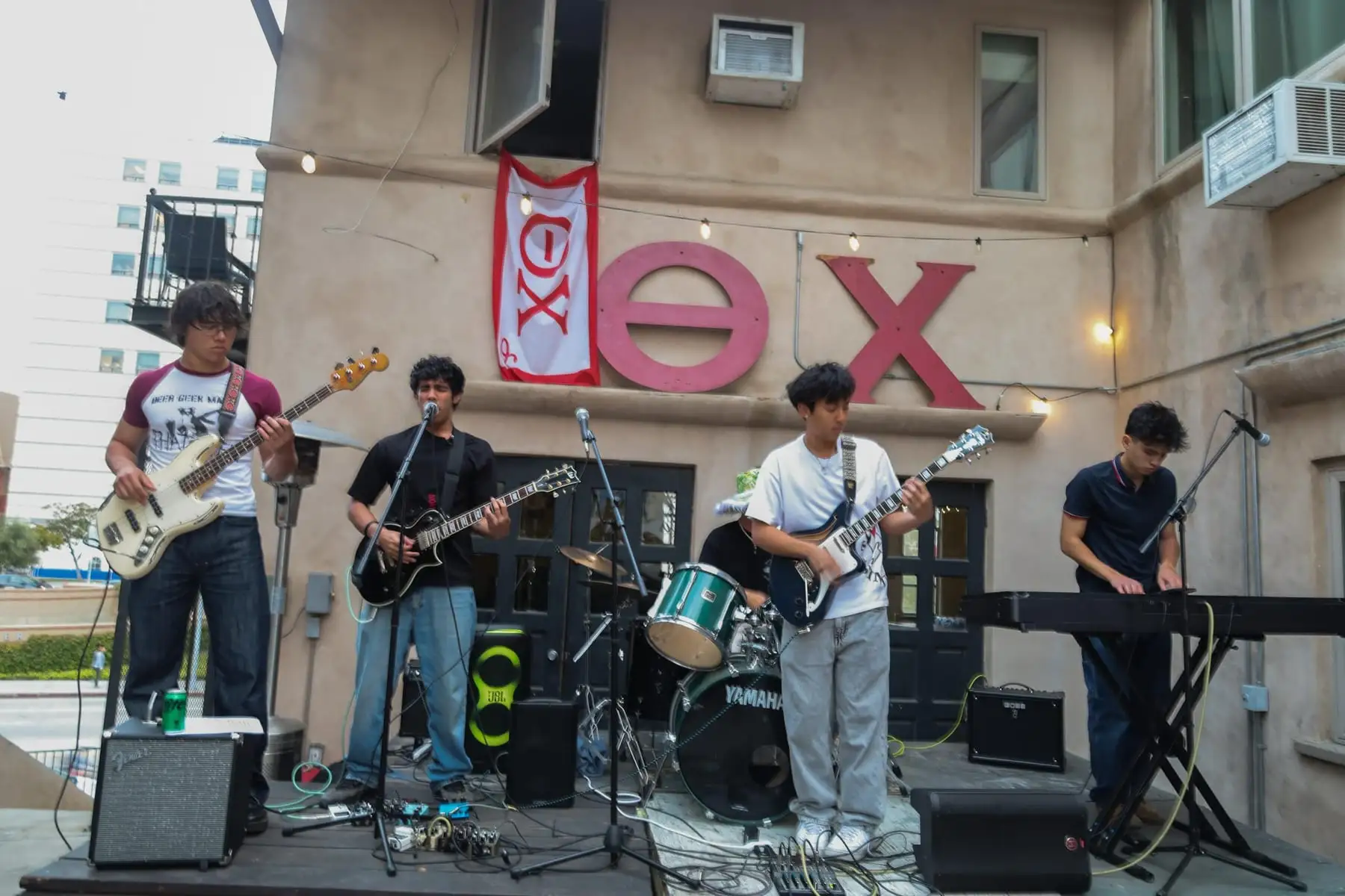 The full band on stage with letter flags flying
