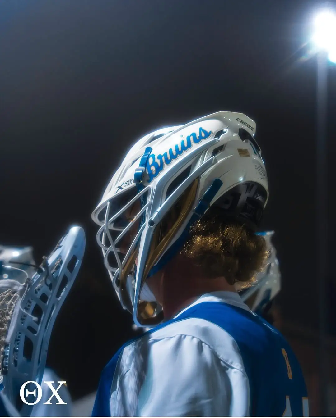 Bruins lacrosse goalie under lights